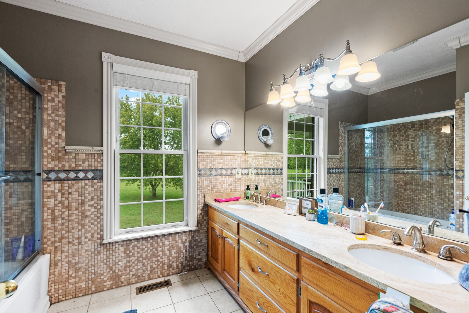 7336 Chowning Road Springfield, TN 37172 - Photo 27 of 45 a bathroom with a sink a large mirror and a shower