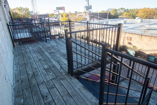 a view of a balcony with wooden floor