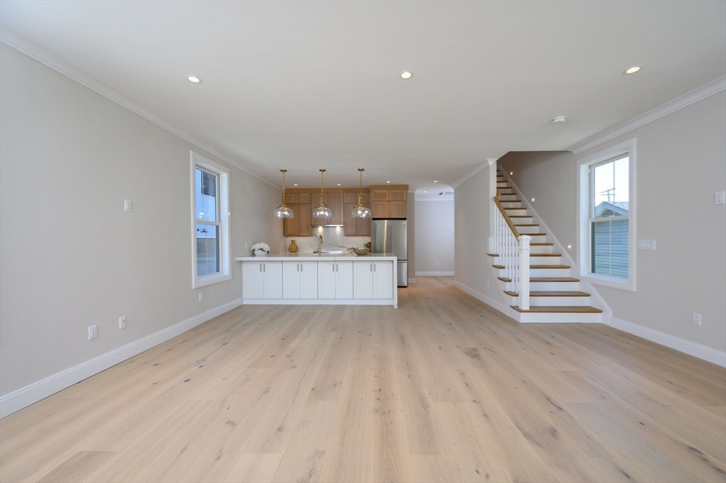 43 Chickatawbut Street, Unit 1 Boston, MA 02122 - Photo 13 of 42 a view of a kitchen with wooden floor and stairs