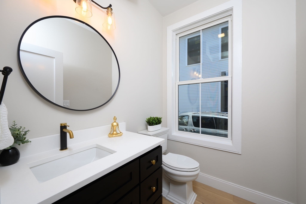 43 Chickatawbut Street, Unit 1 Boston, MA 02122 - Photo 15 of 42 a bathroom with a sink a mirror and a toilet