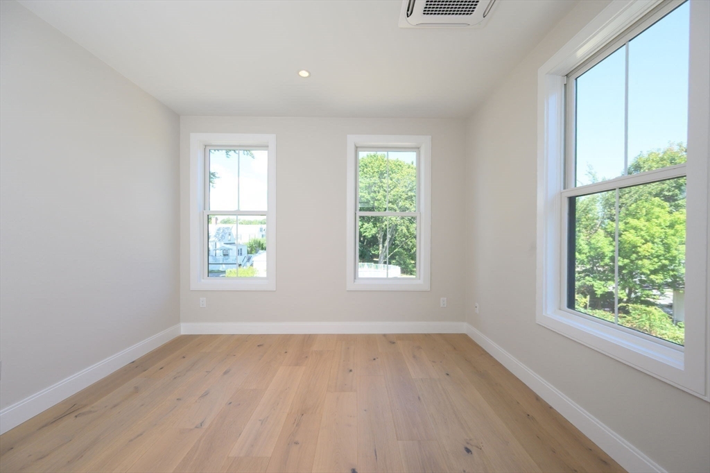 43 Chickatawbut Street, Unit 1 Boston, MA 02122 - Photo 27 of 42 an empty room with wooden floor and windows