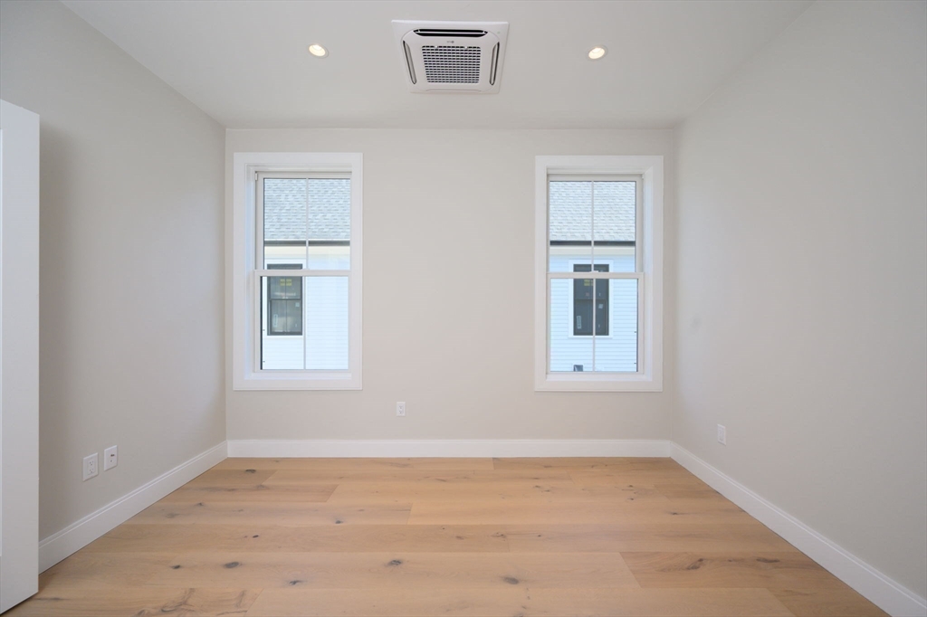43 Chickatawbut Street, Unit 1 Boston, MA 02122 - Photo 30 of 42 an empty room with wooden floor and windows