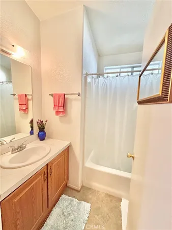 a bathroom with a sink a mirror and a shower