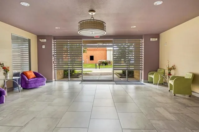 a spacious bathroom with a granite countertop sink and a bathtub