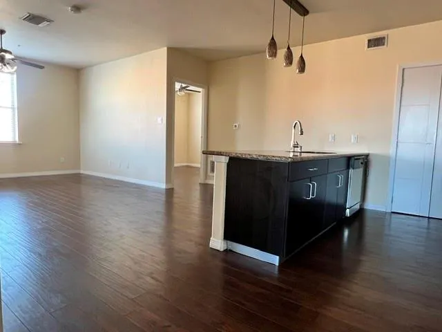 a kitchen with stainless steel appliances a sink stove and refrigerator