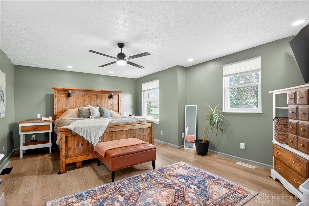 7888 Darke-Preble County Line Road Arcanum, OH 45304 - Photo 25 of 51 This spacious bedroom offers a tranquil retreat with warm wood accents and abundant natural light.