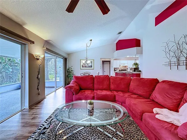 a view of a house with a small yard and a large tree
