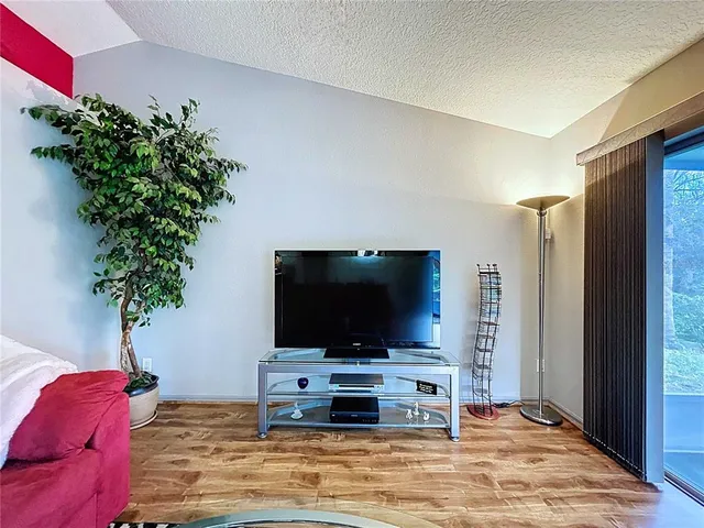 a view of a house with a tree in the yard