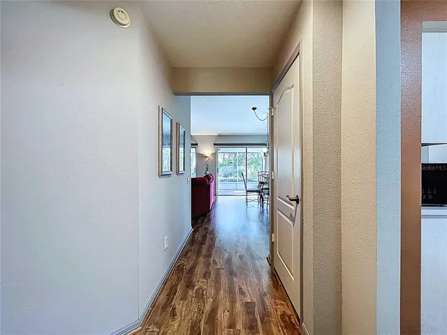 a dining room with furniture a chandelier and wooden floor