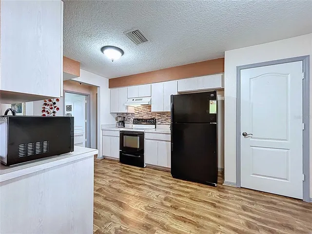 a view of a livingroom with furniture window and wooden floor