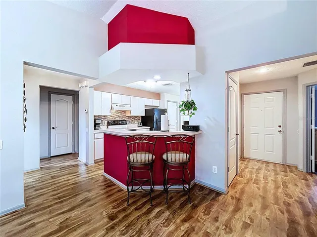 a bathroom with a granite countertop sink toilet mirror and shower
