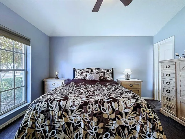 a spacious bedroom with a bed and a chandelier