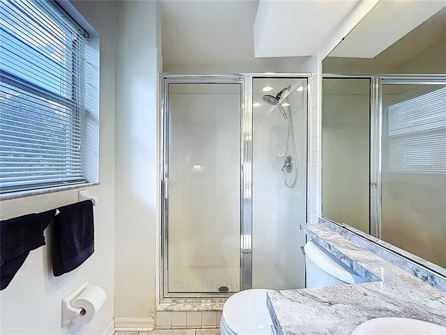 a bathroom with a toilet a sink and a mirror