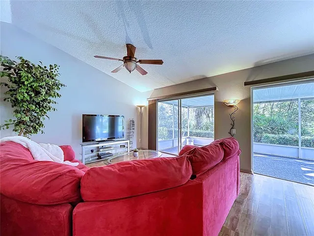 a living room with furniture and a potted plant