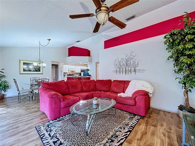 a front view of a house with a garden and trees