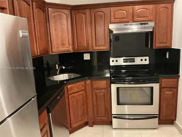 a stove top oven sitting inside of a kitchen