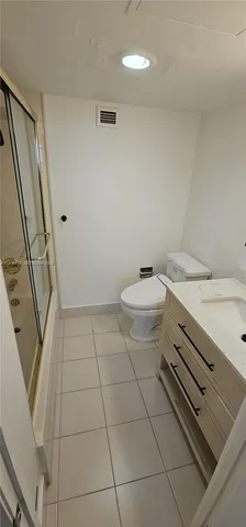 a bathroom with a sink a toilet and a shower