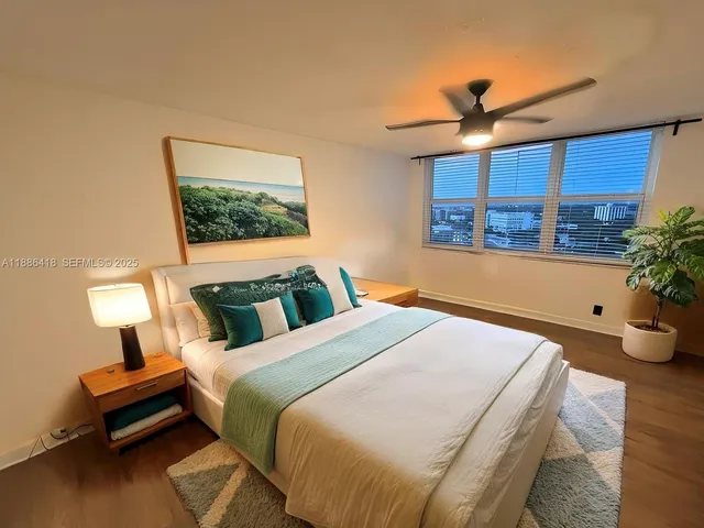 a bed room with a bed and a potted plant