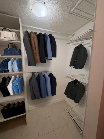a bedroom with a bed and walk in closet