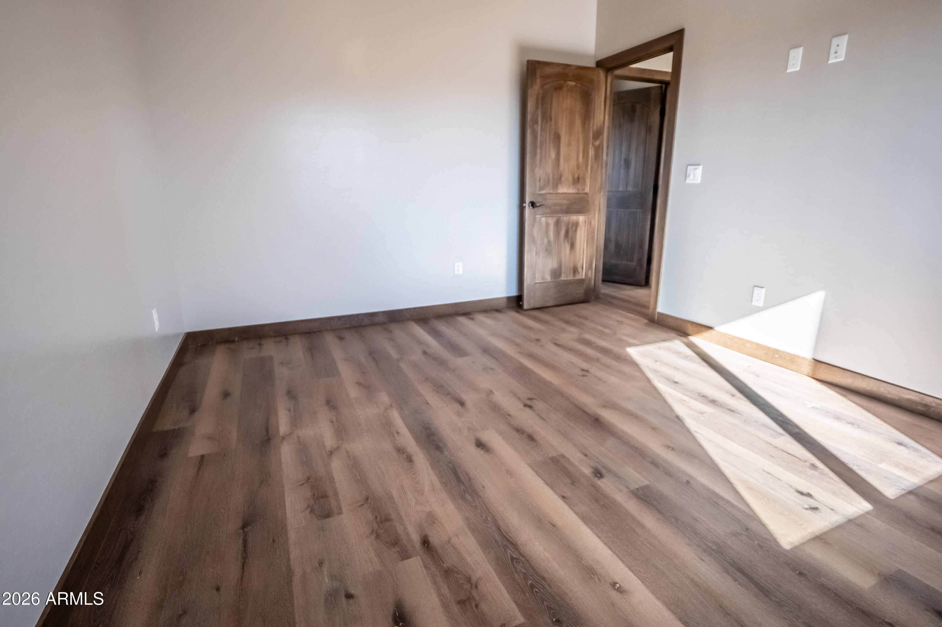 2021 East Rimstone Drive Show Low, AZ 85901 - Photo 22 of 38 a view of an empty room and wooden floor