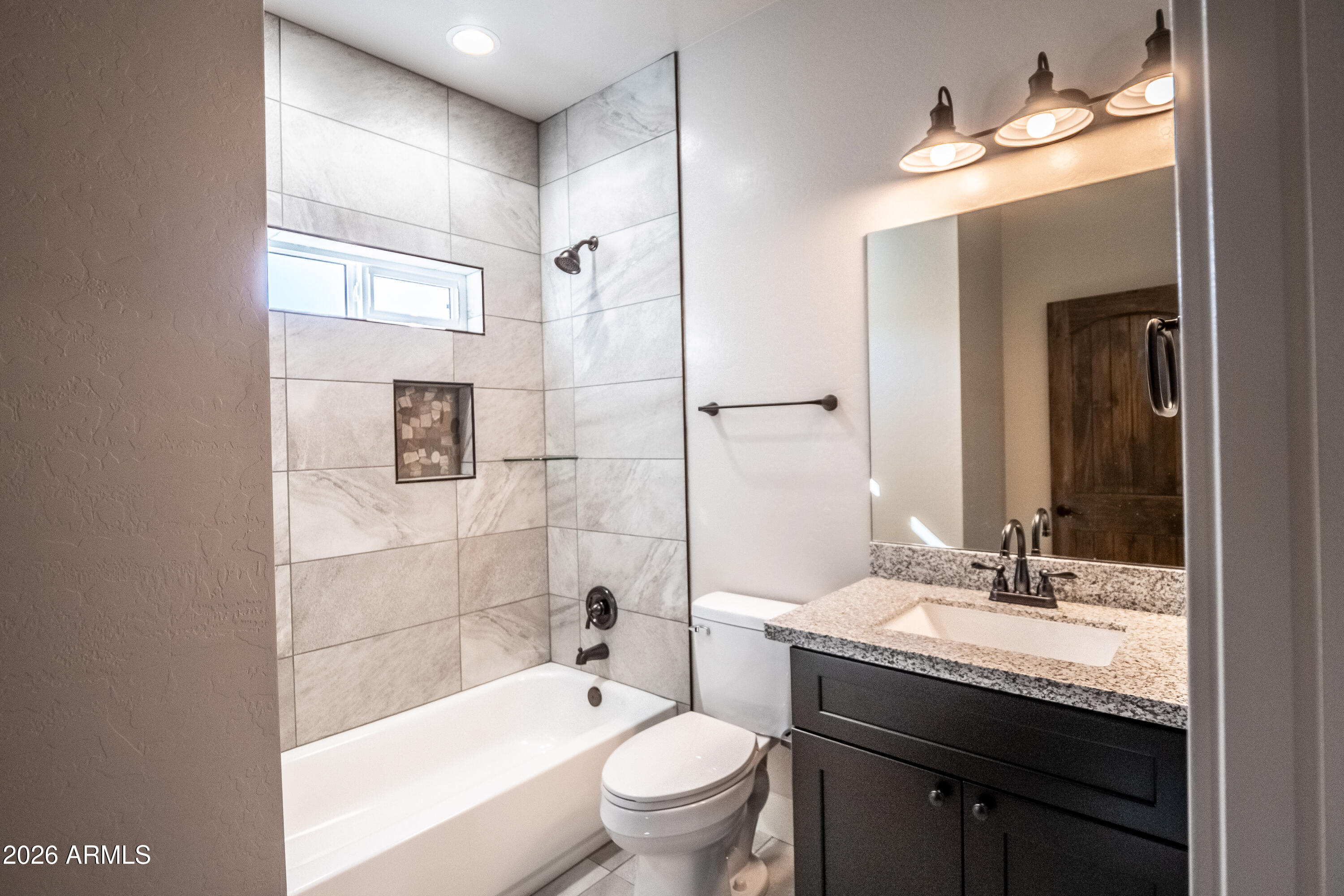 2021 East Rimstone Drive Show Low, AZ 85901 - Photo 30 of 38 a bathroom with a granite countertop sink toilet mirror and shower