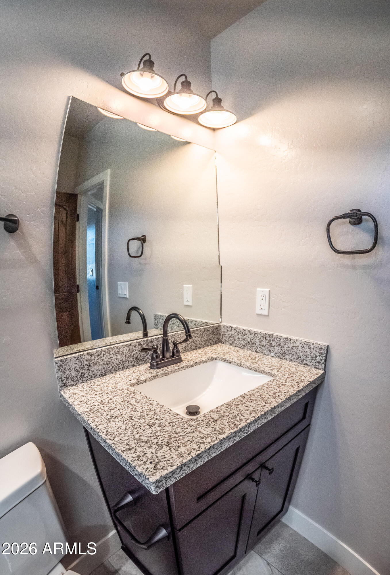 2021 East Rimstone Drive Show Low, AZ 85901 - Photo 31 of 38 a bathroom with a granite countertop sink and a mirror