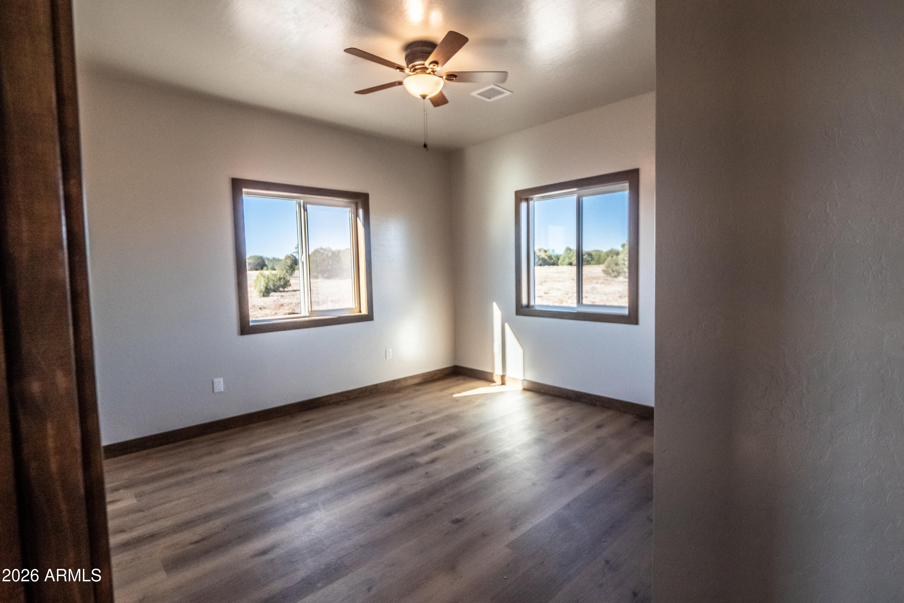 2021 East Rimstone Drive Show Low, AZ 85901 - Photo 34 of 38 a view of an empty room with a window and wooden floor