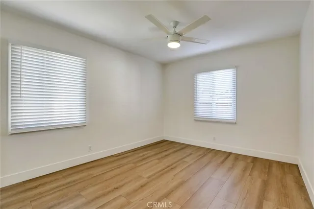 an empty room with wooden floor and door