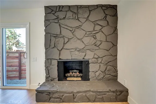 a room with a fireplace and a wooden floor