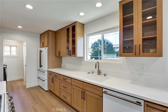 a spacious bathroom with a double vanity sink a large mirror and a bathtub