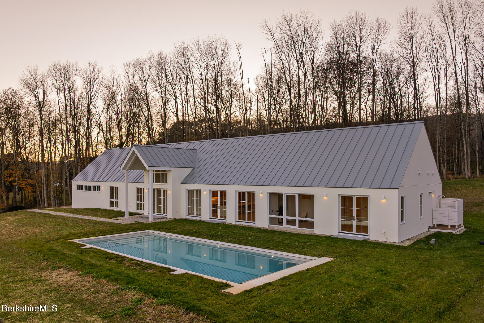 21 A Interlaken Road Stockbridge, MA 01266 - Photo 41 of 43 a front view of house with yard and trees in the background