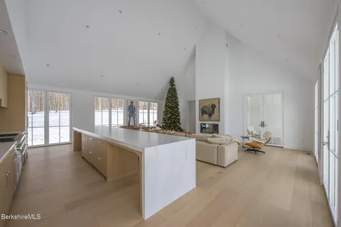 a front view of house with yard and trees in the background