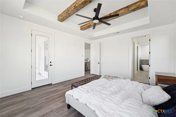 a bedroom with a bed and a ceiling fan