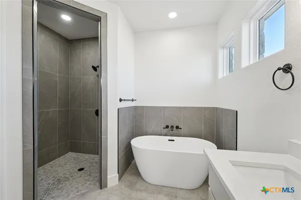 a bathroom with a bathtub and shower