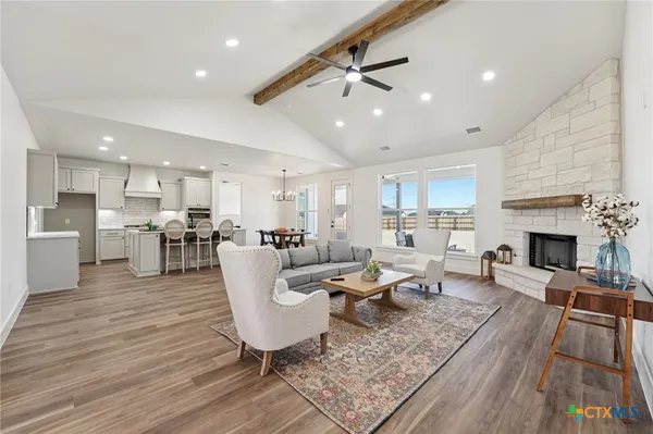 a living room with fireplace furniture and a wooden floor