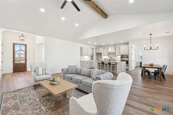 a living room with furniture and kitchen view