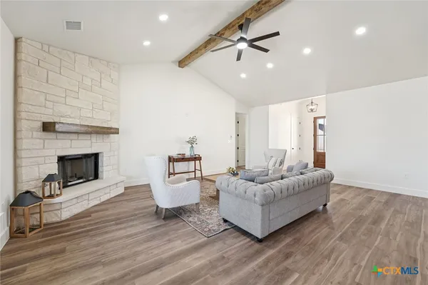 a living room with furniture and a fireplace