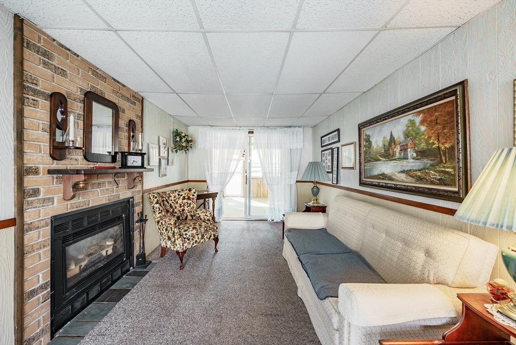 120 Welland Road Springfield, MA 01151 - Photo 7 of 36 a living room with furniture a fireplace and a flat screen tv