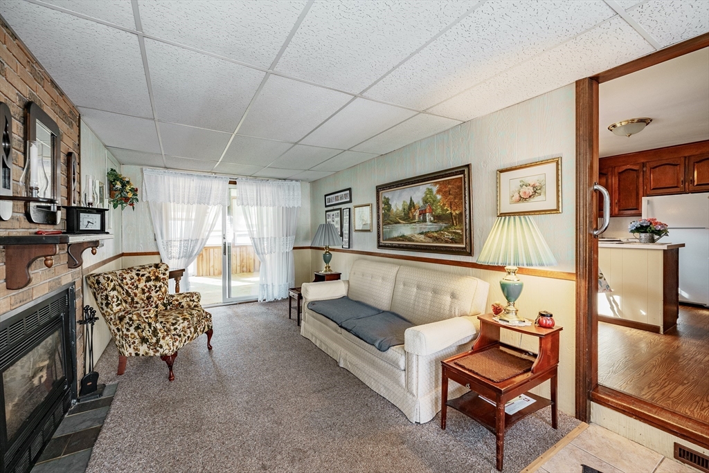 120 Welland Road Springfield, MA 01151 - Photo 8 of 36 a living room with furniture a rug and a chandelier