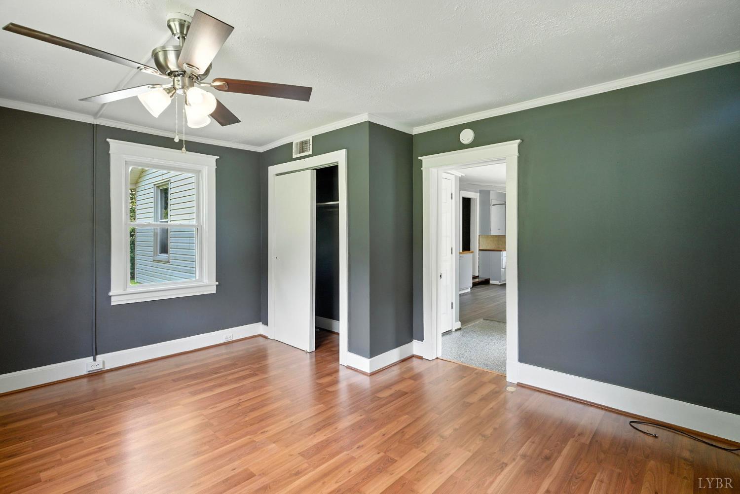 157 Old Country Road Monroe, VA 24574 - Photo 12 of 41 a view of an empty room with wooden floor and a window