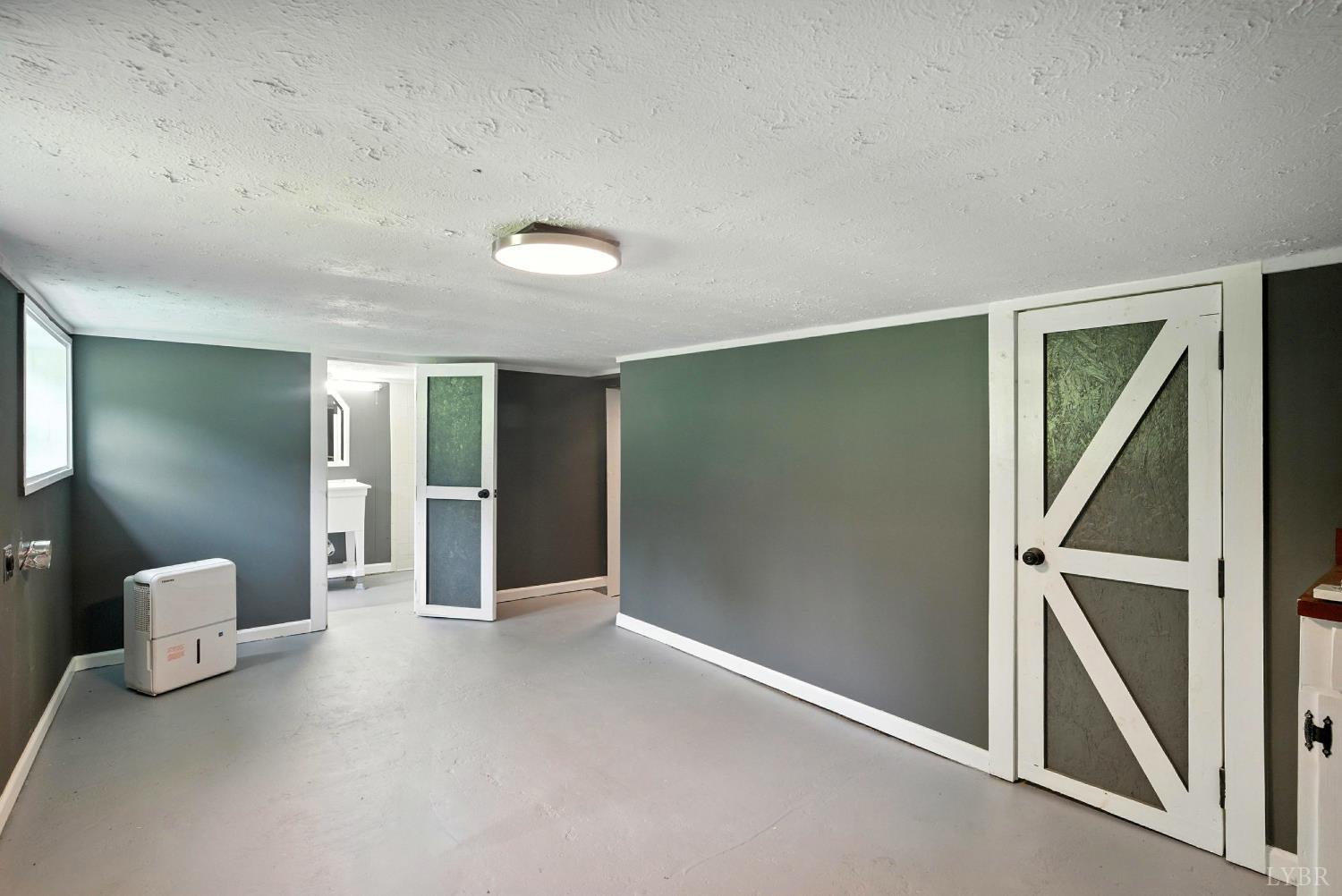 157 Old Country Road Monroe, VA 24574 - Photo 18 of 41 a view of an empty room with wooden floor and a window