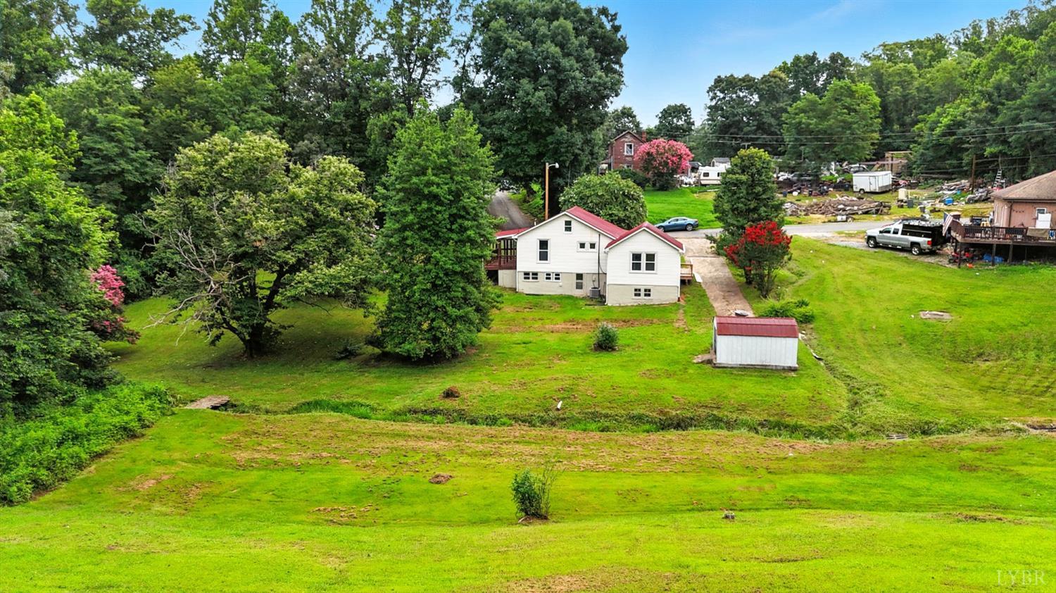 157 Old Country Road Monroe, VA 24574 - Photo 28 of 41 a white house with a yard and swimming pool