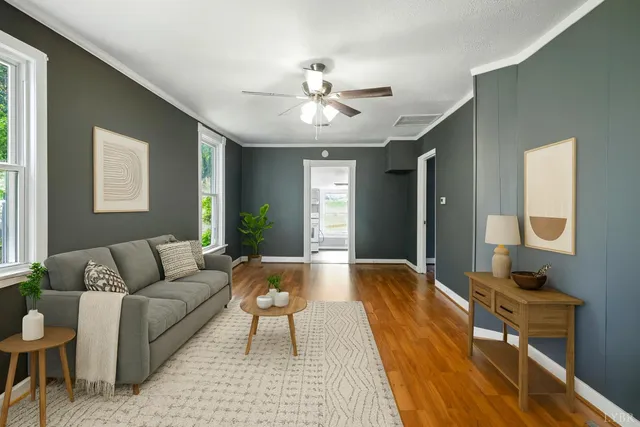 a living room with furniture and a chandelier