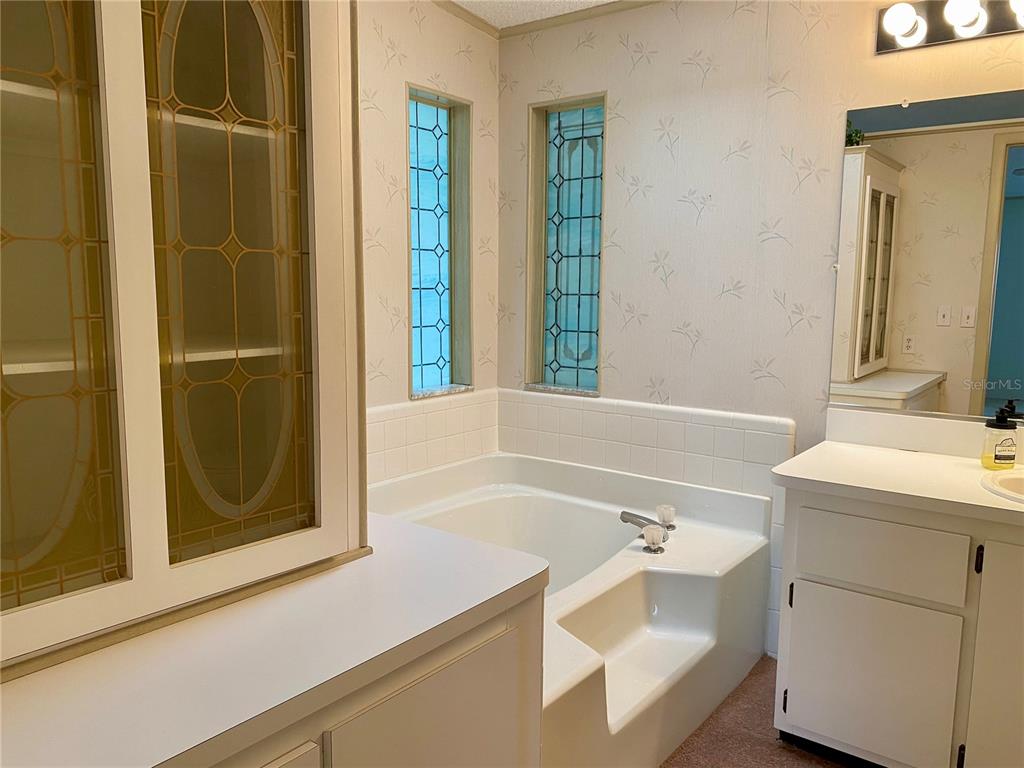 14517 Rialto Avenue Brooksville, FL 34613 - Photo 12 of 35 a bathroom with a bathtub and a sink