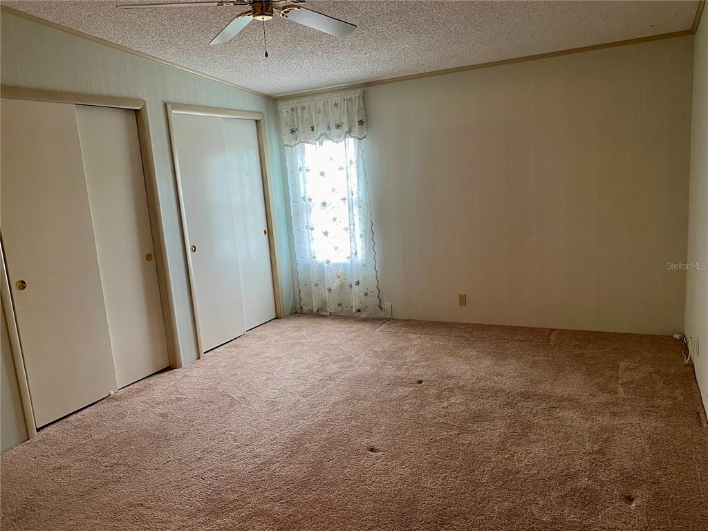 14517 Rialto Avenue Brooksville, FL 34613 - Photo 13 of 35 a view of an empty room and a ceiling fan window