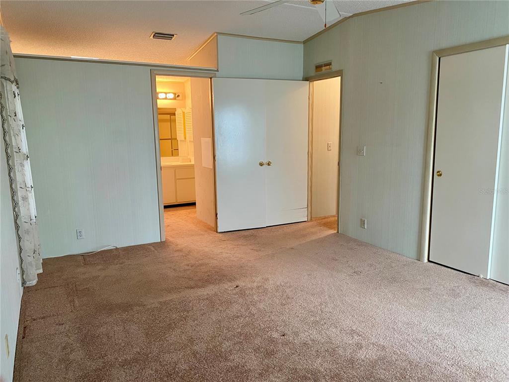 14517 Rialto Avenue Brooksville, FL 34613 - Photo 14 of 35 an empty room with windows and closet