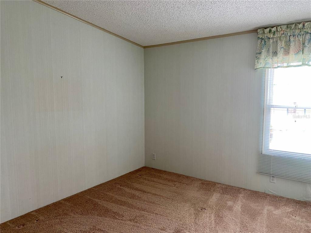 14517 Rialto Avenue Brooksville, FL 34613 - Photo 16 of 35 a view of empty room with window