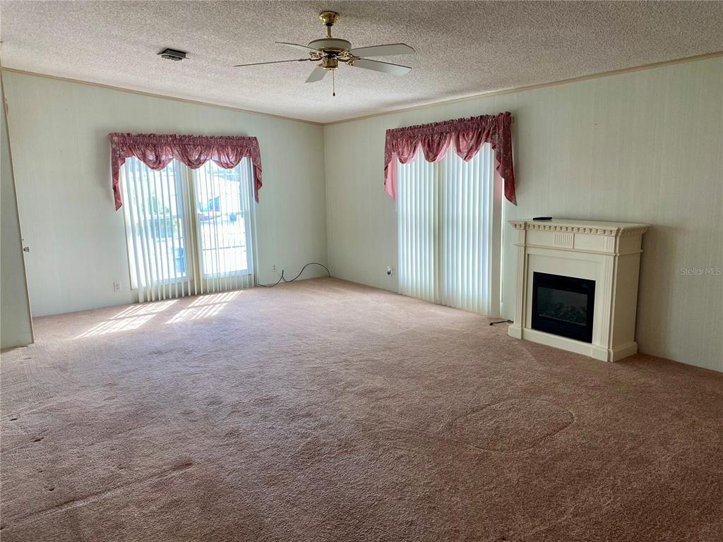 14517 Rialto Avenue Brooksville, FL 34613 - Photo 26 of 35 a view of empty room with a fireplace