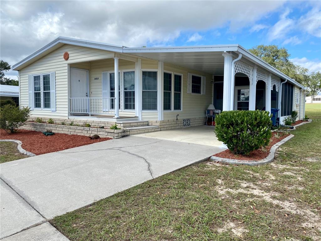 14517 Rialto Avenue Brooksville, FL 34613 - Photo 3 of 35 front view of a brick house with potted plants