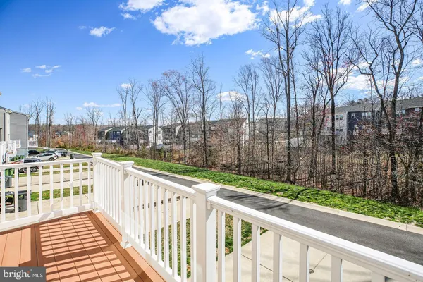 a view of a street with wooden fence